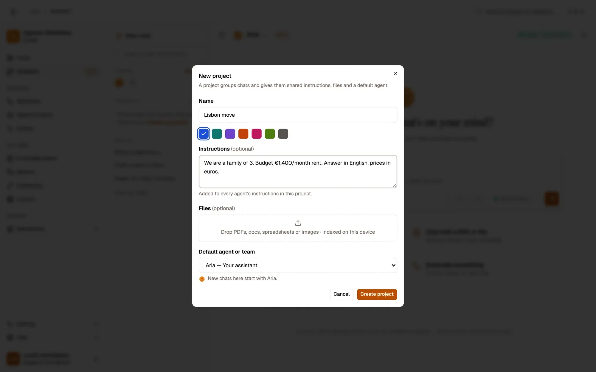 The New project dialog over the Assistant: Name (Lisbon move), a colour, Instructions about the family budget, a Files drop zone indexed on this device, Default agent or team set to Aria, and Cancel and Create project buttons.